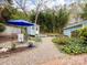 Serene backyard featuring a garden shed, mature trees, and gravel paths at 253 Misenheimer Nw Dr, Concord, NC 28025