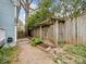 Landscaped backyard with a wooden fence, pergola, and plenty of green space at 253 Misenheimer Nw Dr, Concord, NC 28025