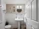 Cozy bathroom featuring a pedestal sink, wainscoting, and classic fixtures at 253 Misenheimer Nw Dr, Concord, NC 28025