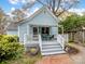 Charming cottage home with a covered front porch, brick walkway, and lush landscaping at 253 Misenheimer Nw Dr, Concord, NC 28025