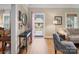 Inviting foyer with hardwood floors, black console table, and a view through the red front door at 253 Misenheimer Nw Dr, Concord, NC 28025