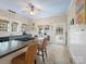 Bright kitchen featuring a kitchen island with seating, tiled floors and natural lighting at 253 Misenheimer Nw Dr, Concord, NC 28025