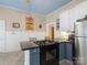 Charming kitchen featuring a gas range, eat-in breakfast bar, and bright natural lighting at 253 Misenheimer Nw Dr, Concord, NC 28025