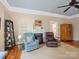 Cozy living room with a fireplace, comfortable armchairs, hardwood floors, and neutral decor at 253 Misenheimer Nw Dr, Concord, NC 28025