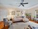 Bright living room features a comfortable sectional sofa, hardwood floors, and a large window at 253 Misenheimer Nw Dr, Concord, NC 28025