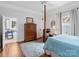 Comfortable main bedroom with hardwood floors, a four-poster bed, and an attached bathroom at 253 Misenheimer Nw Dr, Concord, NC 28025