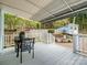 Relaxing patio with covered seating area, a dining table, and backyard garden views at 253 Misenheimer Nw Dr, Concord, NC 28025