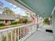 Inviting front porch with white railing, view of the landscaped yard and street, featuring an American flag at 253 Misenheimer Nw Dr, Concord, NC 28025