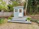 Backyard shed with wooden porch, neutral paint, and well-manicured landscaping at 253 Misenheimer Nw Dr, Concord, NC 28025