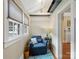 Cozy sitting area with a comfortable armchair, bright windows, and wood flooring at 253 Misenheimer Nw Dr, Concord, NC 28025