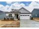 New construction single-Gathering home with stone accents, covered entryway, and attached two car garage at 3009 Bent Willow Dr # 160, Indian Trail, NC 28079