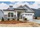 New construction single-Gathering home with stone accents, covered entryway, and attached two car garage at 3009 Bent Willow Dr # 160, Indian Trail, NC 28079