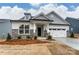 New construction single-Gathering home with stone accents, covered entryway, and attached two car garage at 3009 Bent Willow Dr # 160, Indian Trail, NC 28079