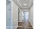 Bright hallway featuring classic wainscoting, tray ceiling, and hard surface floors at 3009 Bent Willow Dr # 160, Indian Trail, NC 28079