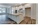 Gourmet kitchen featuring oversized island with granite counters and modern stainless steel appliances at 3009 Bent Willow Dr # 160, Indian Trail, NC 28079