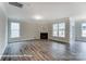 Spacious living room featuring hardwood floors, large windows, and a cozy fireplace at 3009 Bent Willow Dr # 160, Indian Trail, NC 28079