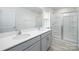 Bright bathroom with double sink vanity, quartz countertops, and a glass-enclosed shower stall at 327 Brinkley Dr # 107, Kings Mountain, NC 28086