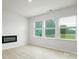 Bright living room with electric fireplace and large windows overlooking yard at 327 Brinkley Dr # 107, Kings Mountain, NC 28086
