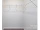 Empty walk-in closet features carpeted floor and shelving units at 327 Brinkley Dr # 107, Kings Mountain, NC 28086