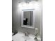 Bathroom vanity with a white sink, decorative mirror and light fixture, candle holder and modern faucet at 3240 Heathstead Pl, Charlotte, NC 28210