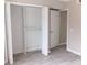 A bright bedroom closet with a double door entry and modern vinyl flooring at 3240 Heathstead Pl, Charlotte, NC 28210