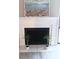 Bright fireplace featuring white tile and mantle with black interior and artwork above at 3240 Heathstead Pl, Charlotte, NC 28210