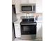 Close up of the stainless steel stove and microwave in the kitchen at 3240 Heathstead Pl, Charlotte, NC 28210