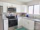 This kitchen features white cabinets, granite countertops, and stainless steel appliances at 3240 Heathstead Pl, Charlotte, NC 28210