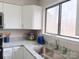 Kitchen sink with granite countertops and white cabinets with a view to the outside at 3240 Heathstead Pl, Charlotte, NC 28210