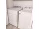 Well-maintained white Whirlpool washer and dryer in the laundry room with luxury vinyl flooring at 3240 Heathstead Pl, Charlotte, NC 28210
