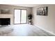 Open concept living room featuring a fireplace and a sliding glass door at 3240 Heathstead Pl, Charlotte, NC 28210