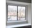 View from a window overlooking the parking lot, community lawns, and adjacent townhomes on an overcast day at 3240 Heathstead Pl, Charlotte, NC 28210