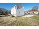 Exterior view of the backyard with a back entrance, a small porch and a concrete parking area at 418 N Pear St, Gastonia, NC 28054
