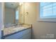 Bathroom featuring a granite countertop, vanity, mirror, and window at 418 N Pear St, Gastonia, NC 28054