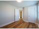 Bedroom featuring a large window, door, and durable laminate flooring at 418 N Pear St, Gastonia, NC 28054