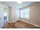 Bedroom featuring a large window, door, and durable laminate flooring at 418 N Pear St, Gastonia, NC 28054