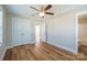 This spacious bedroom features wood floors, ceiling fan, and closet for ample storage at 418 N Pear St, Gastonia, NC 28054