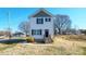 Two-story home with light siding, black shutters, simple landscaping and a small porch entry at 418 N Pear St, Gastonia, NC 28054
