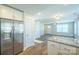 Bright, open kitchen features stainless steel refrigerator and granite countertops at 418 N Pear St, Gastonia, NC 28054