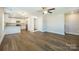 Open-concept living room with wood-look flooring that seamlessly flows into the modern kitchen at 418 N Pear St, Gastonia, NC 28054