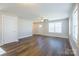 Spacious open-plan living room with hardwood floors and natural light beaming through large windows at 418 N Pear St, Gastonia, NC 28054