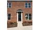 Charming brick home featuring a black front door with a classic awning and white trim at 435 Beacon Nw St, Concord, NC 28027