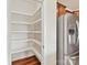 Well-organized walk-in pantry with ample shelving next to the stainless steel refrigerator at 5048 Redwood Grove Trl, Lancaster, SC 29720