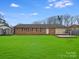 A beautiful backyard with green grass and a raised patio at 712 Stevens St, Gastonia, NC 28054