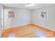 Bright bedroom with hardwood floors and two windows offers a light-filled living space at 712 Stevens St, Gastonia, NC 28054