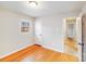 This bedroom features hardwood floors, a window, and doorway with white trim at 712 Stevens St, Gastonia, NC 28054