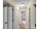 Hallway with neutral carpeting and several doorways provides access to various rooms at 712 Stevens St, Gastonia, NC 28054