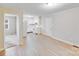 Open concept living room leading to a kitchen with wood-look floors and neutral paint tones at 712 Stevens St, Gastonia, NC 28054