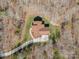 Bird's-eye view of a home featuring a long drive and landscaping, secluded by trees at 809 Liberty Rd, Gold Hill, NC 28071