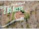 Aerial view of brick ranch home on 2.85 acres with large driveway surrounded by mature trees at 809 Liberty Rd, Gold Hill, NC 28071